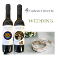 Two bottles of Catholic Olive Oil with wedding rings on a white background