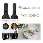 Two bottles of Catholic Olive Oil with wedding rings on a white background